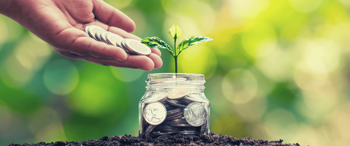 The concept of growing savings through investment in a condo, represented by a jar of coins with a small tree growing out of it.